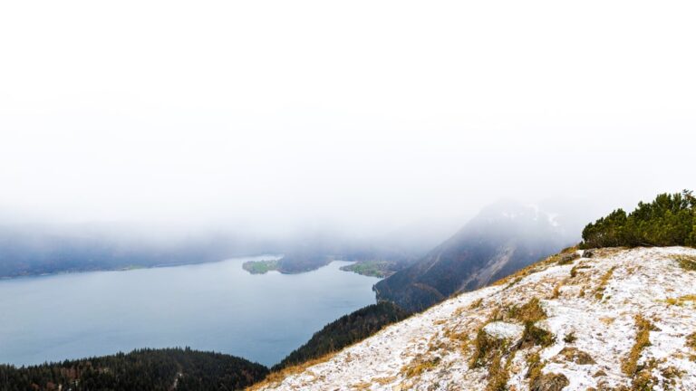 Clouds drift over Kochelsee and Walchensee, seen from the lightly snow covered slopes of Jochberg
