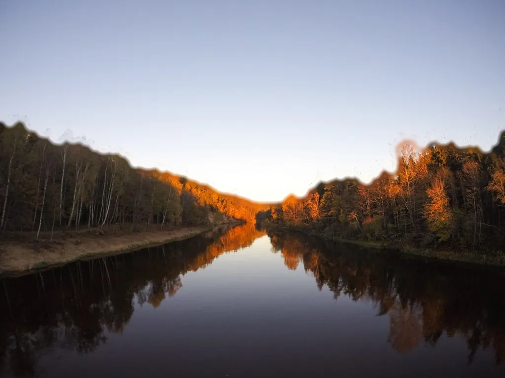 A still river between autumn forests in Gauja National Park